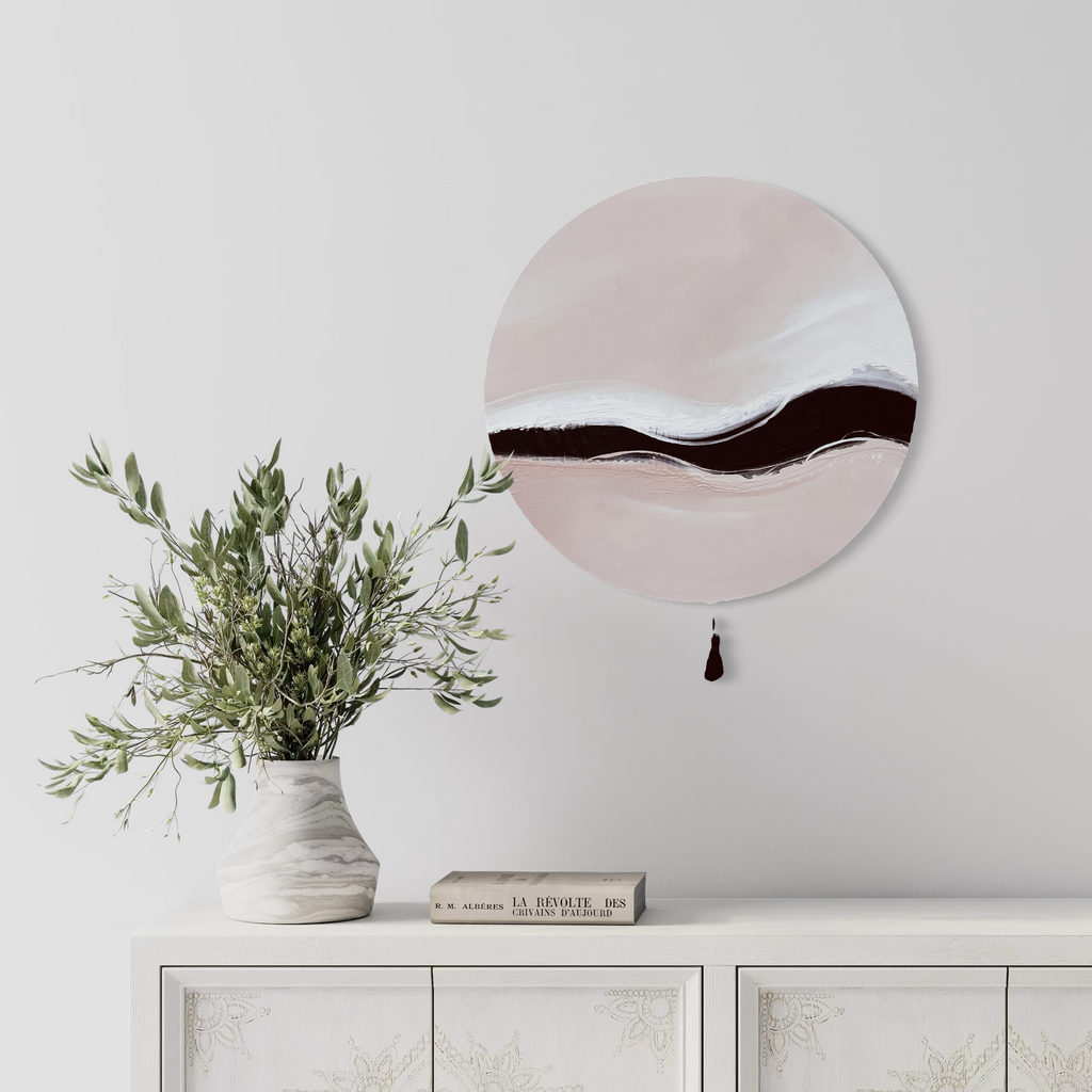 Kunstwerk warm wave Nadine Elsner modern Wabi Sabi Art. Das Werk hängt über einer weißen, mit Mustern verzierten Kommode. Auf ihr steht eine marmorierte Vase mit einem Eukalyptusstrauss und neben ihr liegt ein Buch.